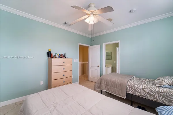 a front view of a house with a lot of potted plants