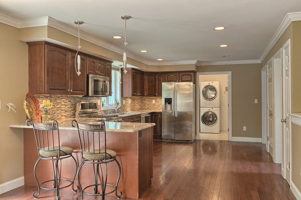 72 Clement Road Dracut, MA 01826 - Photo 11 of 30 a kitchen with stainless steel appliances kitchen island granite countertop a refrigerator and a stove top oven