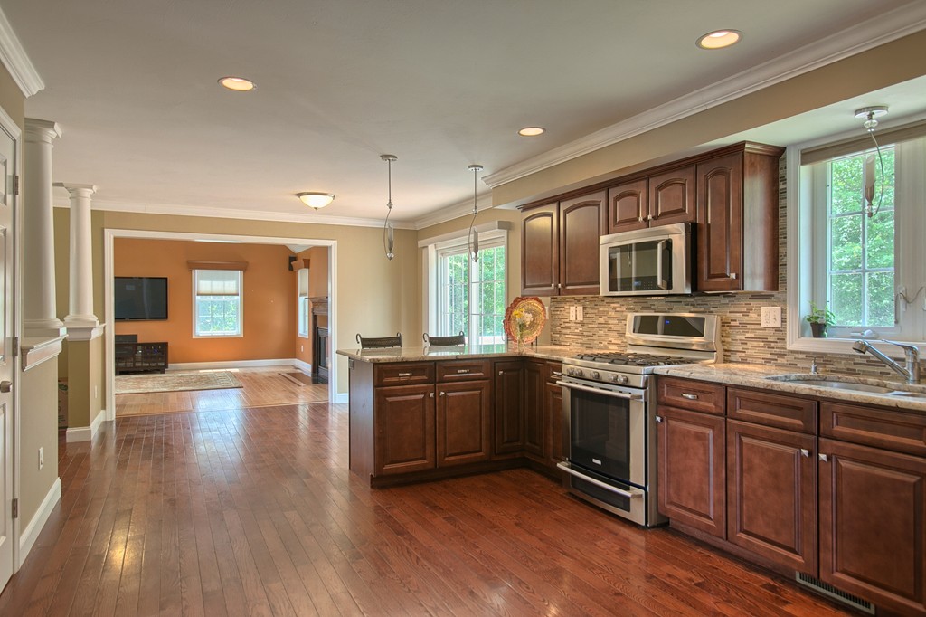 72 Clement Road Dracut, MA 01826 - Photo 12 of 30 a large kitchen with stainless steel appliances granite countertop a stove and cabinets