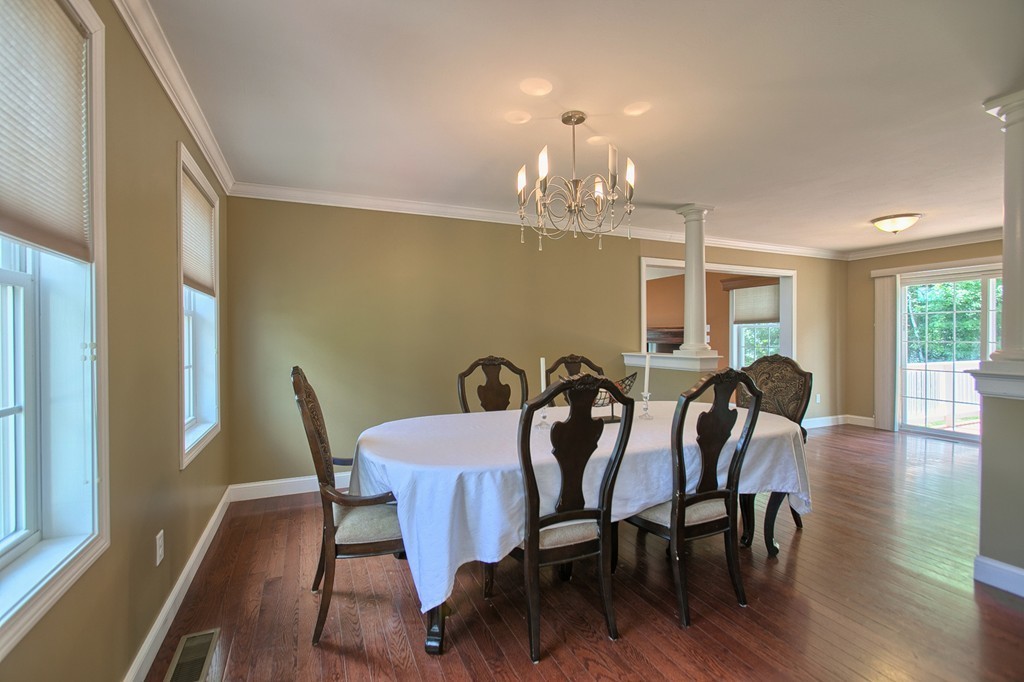 72 Clement Road Dracut, MA 01826 - Photo 16 of 30 a view of a dining room with furniture a chandelier and wooden floor