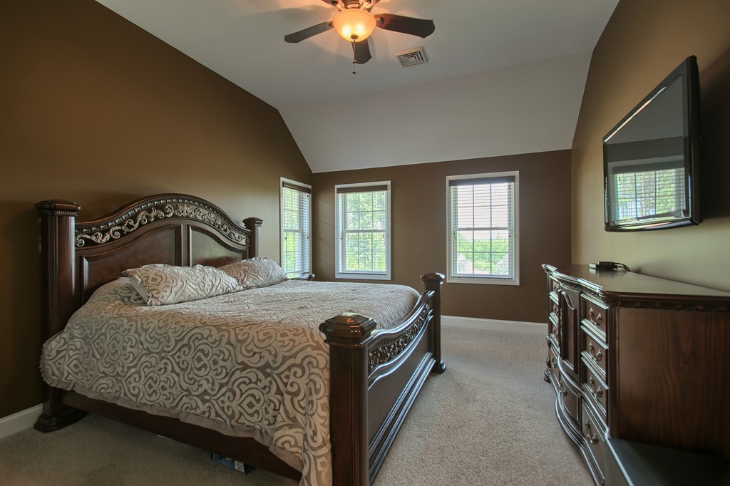 72 Clement Road Dracut, MA 01826 - Photo 19 of 30 a bedroom with a bed and a chandelier