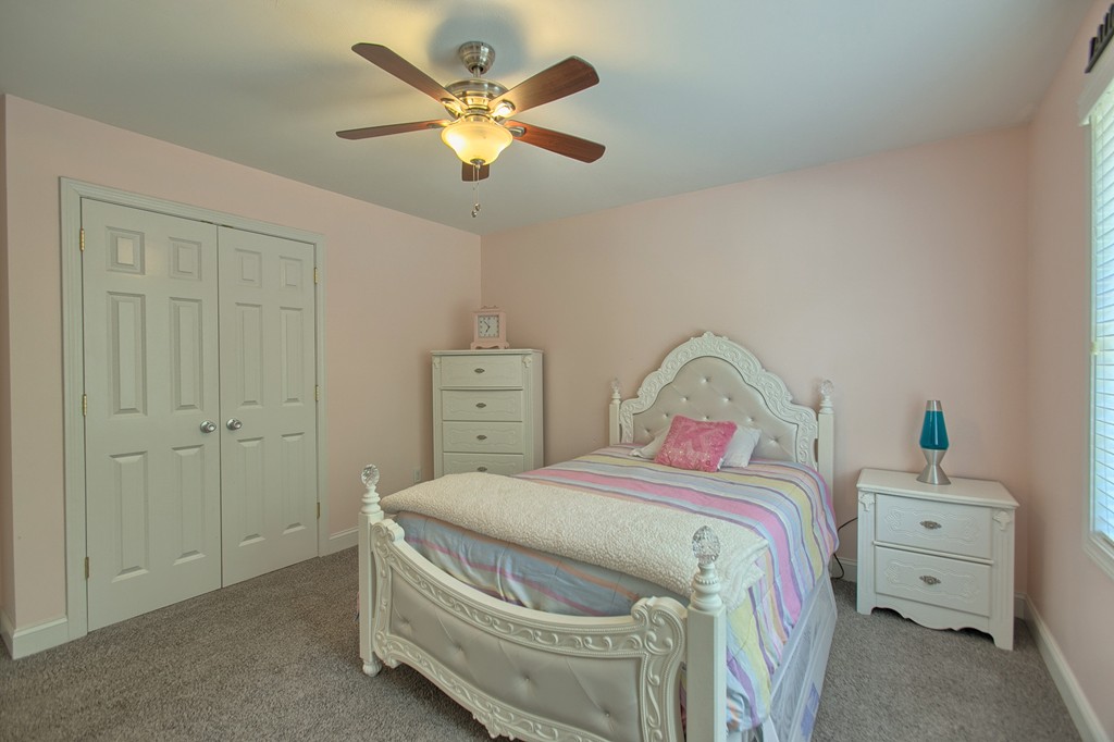 72 Clement Road Dracut, MA 01826 - Photo 24 of 30 a bedroom with a bed and a chandelier