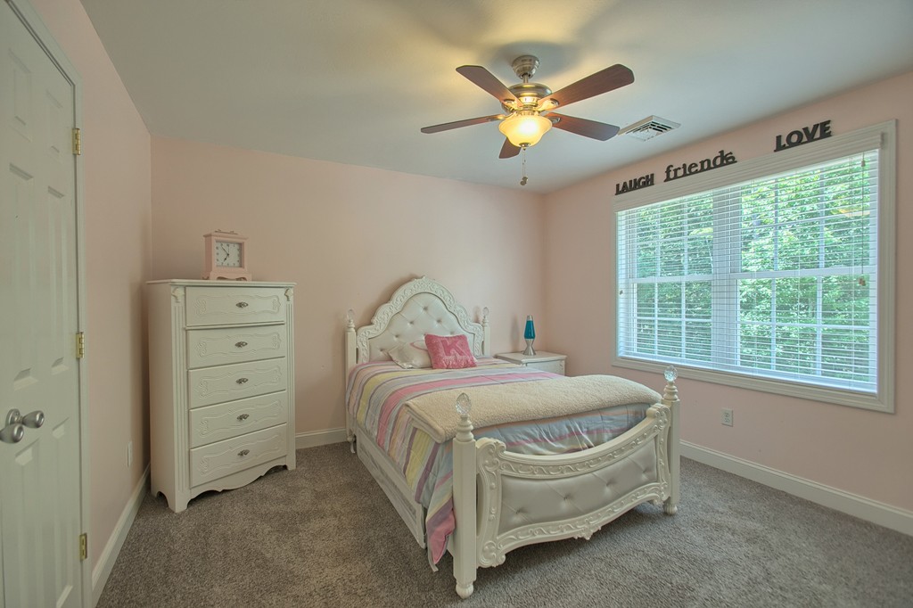 72 Clement Road Dracut, MA 01826 - Photo 25 of 30 a bedroom with a bed and a chandelier