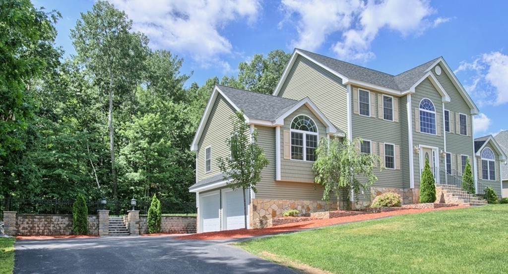 72 Clement Road Dracut, MA 01826 - Photo 3 of 30 a front view of a house with a yard and garage