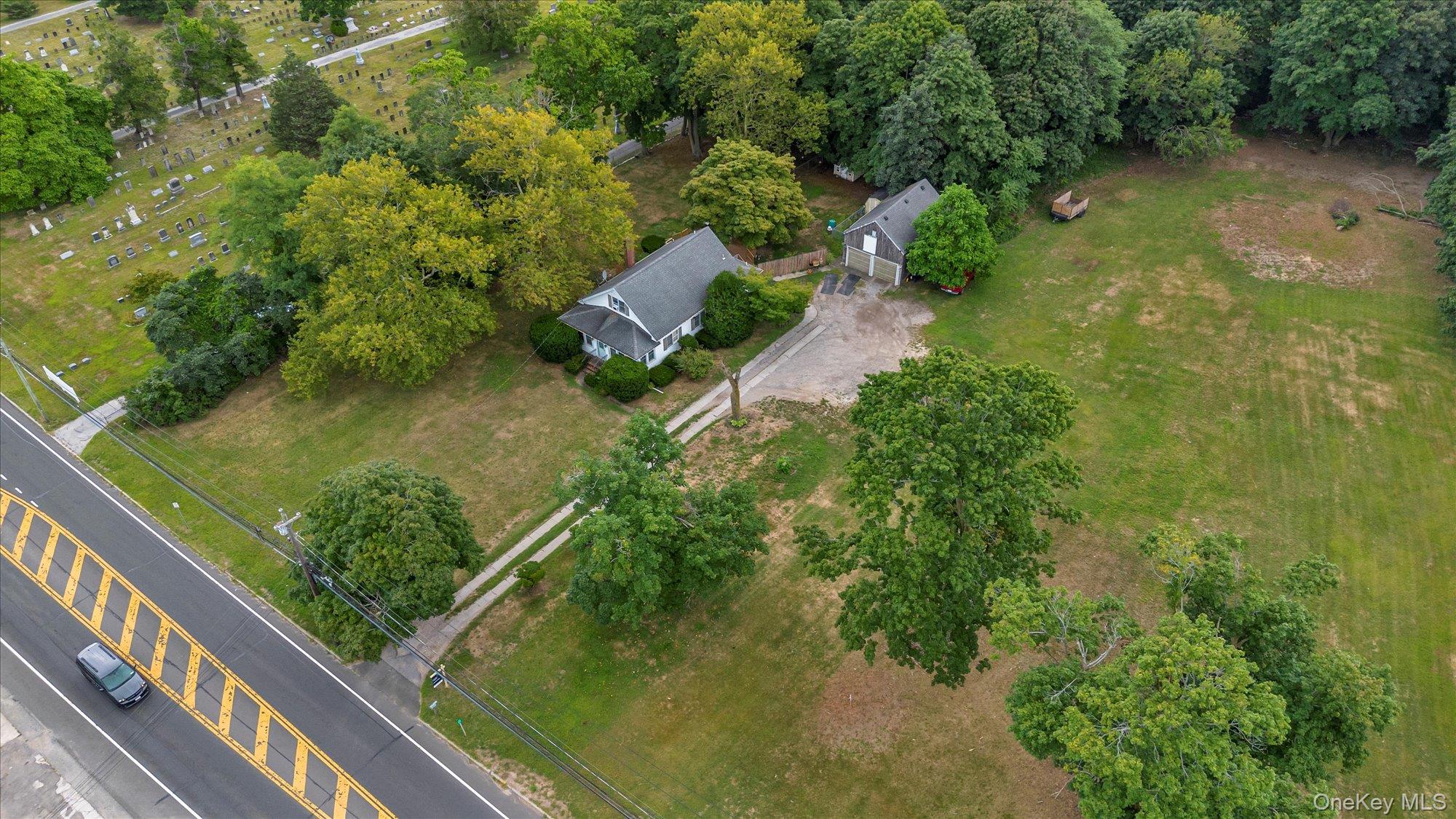 653 Main Road Aquebogue, NY 11901 - Photo 14 of 19 an aerial view of residential house with outdoor space and trees all around