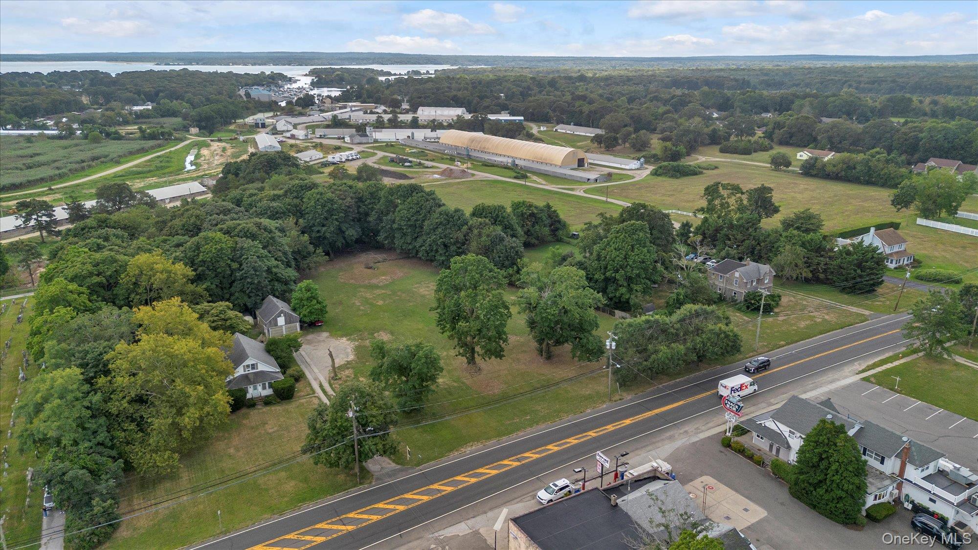 653 Main Road Aquebogue, NY 11901 - Photo 15 of 19 an aerial view of residential houses with outdoor space and river