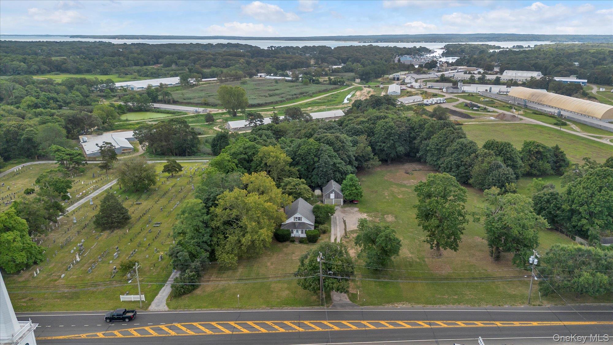 653 Main Road Aquebogue, NY 11901 - Photo 16 of 19 an aerial view of residential houses with outdoor space and trees