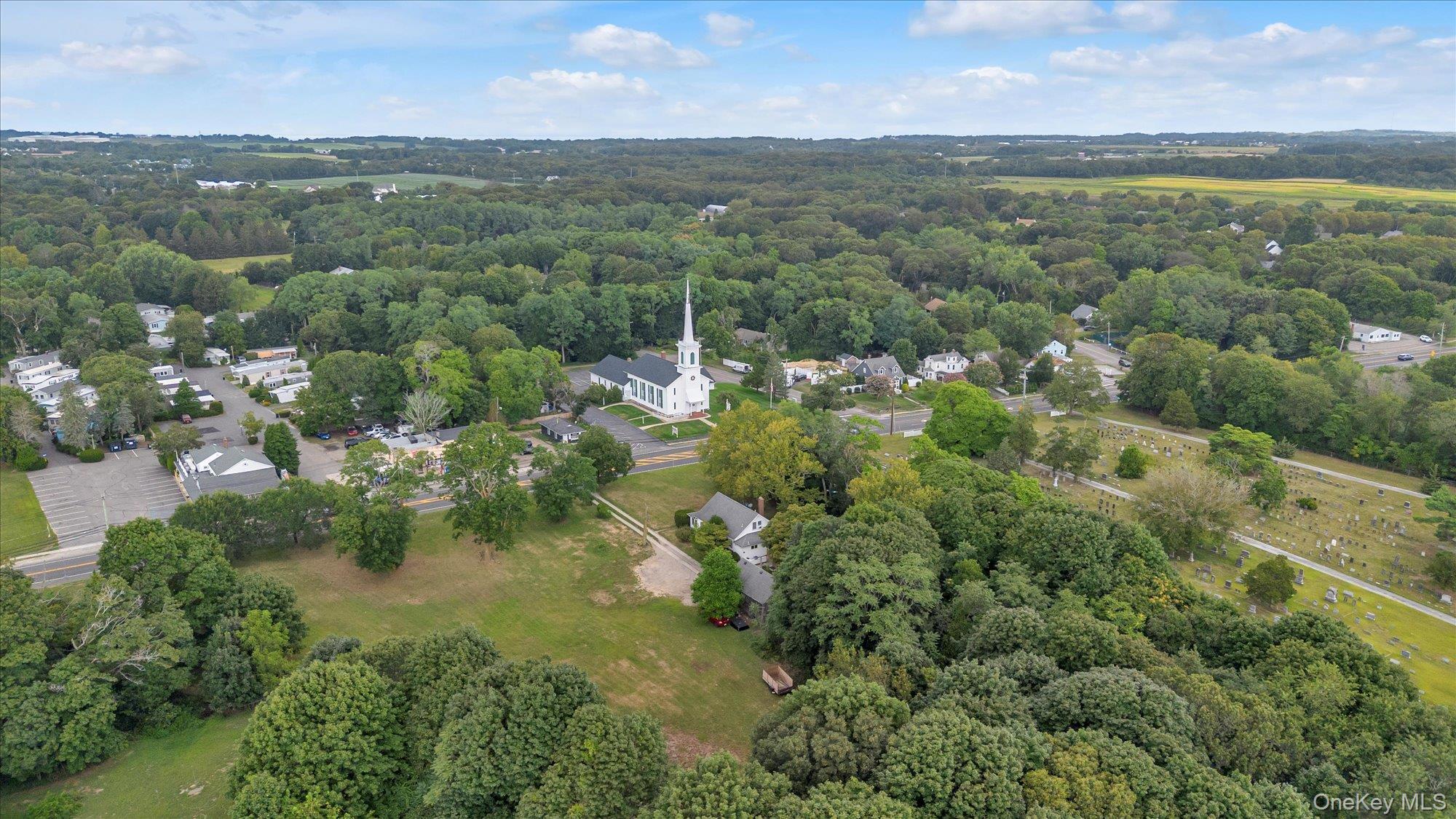 653 Main Road Aquebogue, NY 11901 - Photo 18 of 19 an aerial view of residential houses with outdoor space and trees