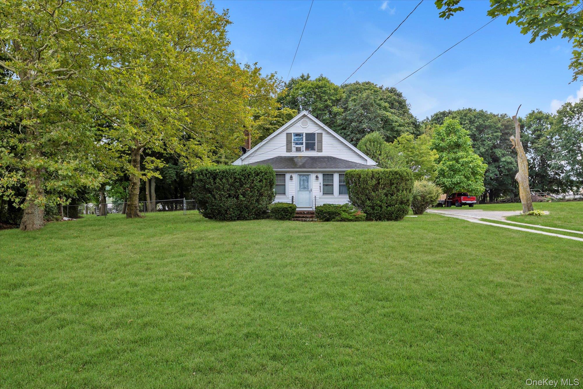 653 Main Road Aquebogue, NY 11901 - Photo 5 of 19 a front view of a house with a yard