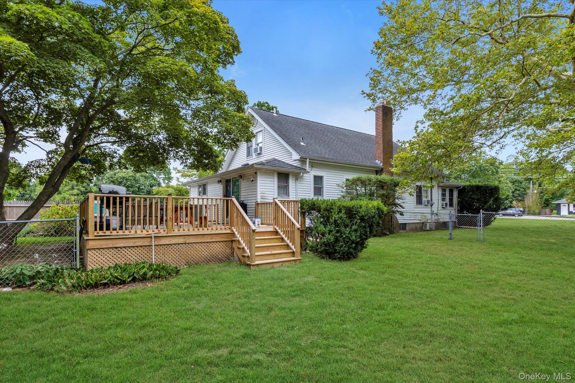 653 Main Road Aquebogue, NY 11901 - Photo 8 of 19 a front view of a house with a yard porch and furniture