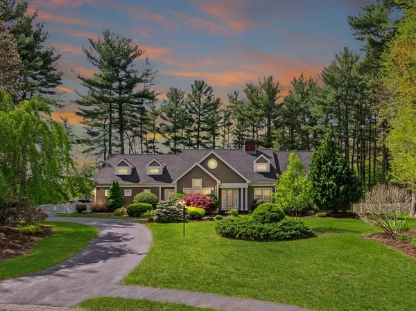 a view of house with garden and tall trees