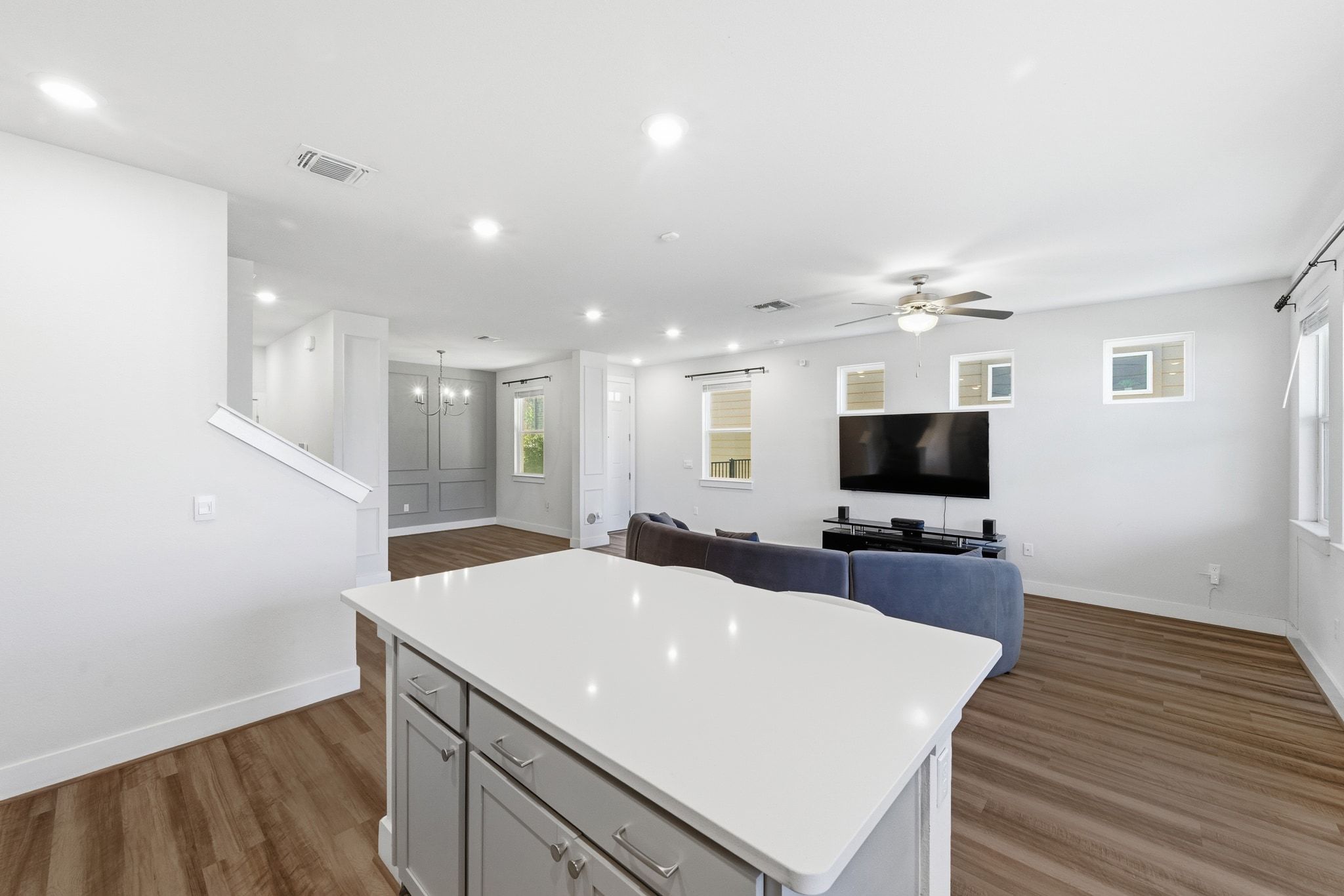 7416 Travertine Spring Drive, Unit 149 Austin, TX 78744 - Photo 14 of 36 a large white kitchen with wooden floor and a sink