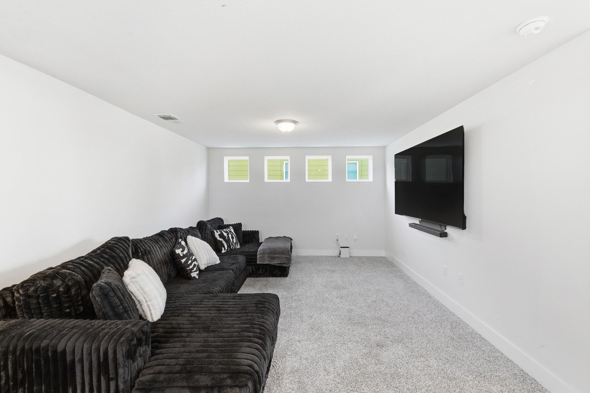 7416 Travertine Spring Drive, Unit 149 Austin, TX 78744 - Photo 18 of 36 a living room with furniture and a flat screen tv