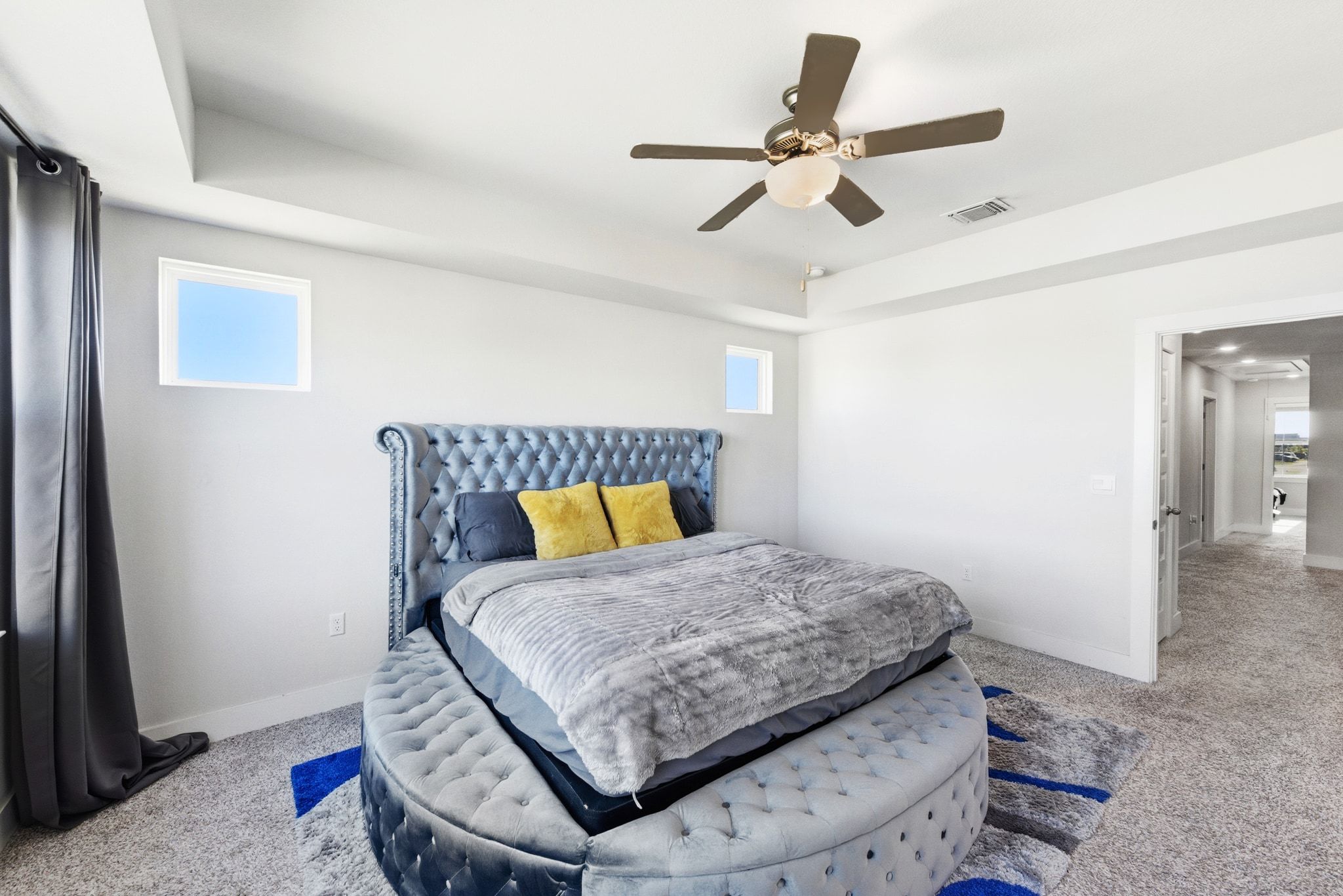 7416 Travertine Spring Drive, Unit 149 Austin, TX 78744 - Photo 20 of 36 a bedroom with a bed and ceiling fan