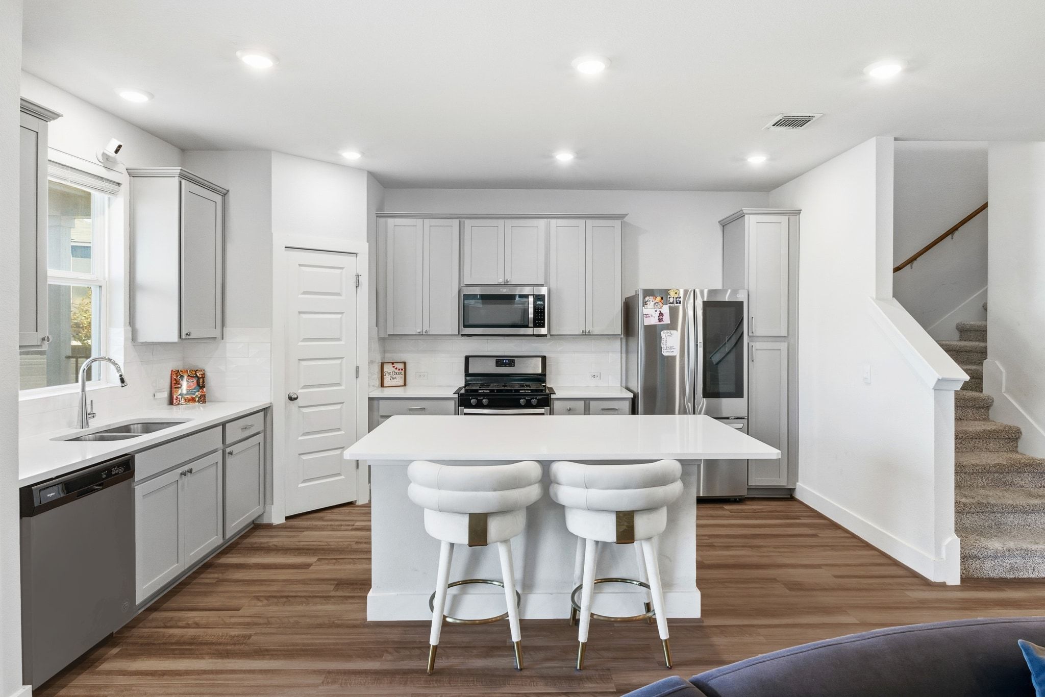 7416 Travertine Spring Drive, Unit 149 Austin, TX 78744 - Photo 2 of 36 a kitchen with stainless steel appliances a dining table chairs microwave and sink