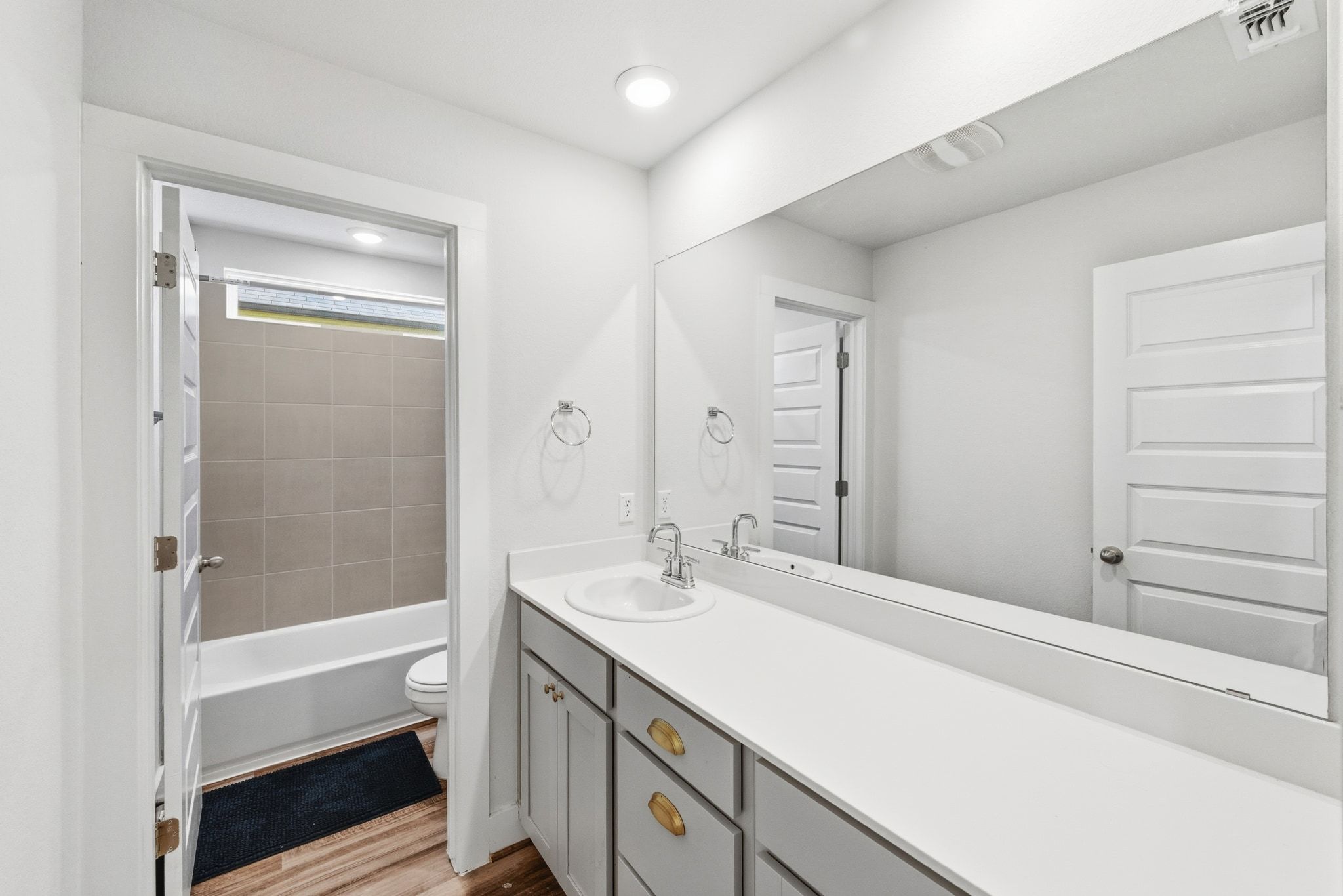 7416 Travertine Spring Drive, Unit 149 Austin, TX 78744 - Photo 27 of 36 a bathroom with a sink a toilet and shower