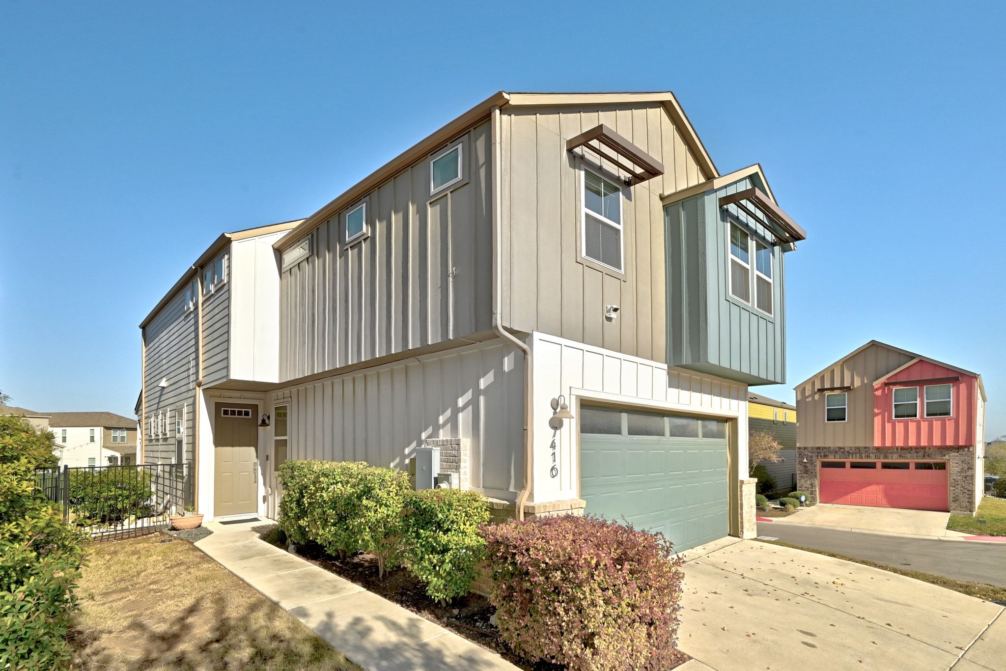 7416 Travertine Spring Drive, Unit 149 Austin, TX 78744 - Photo 35 of 36 a front view of a house with a yard