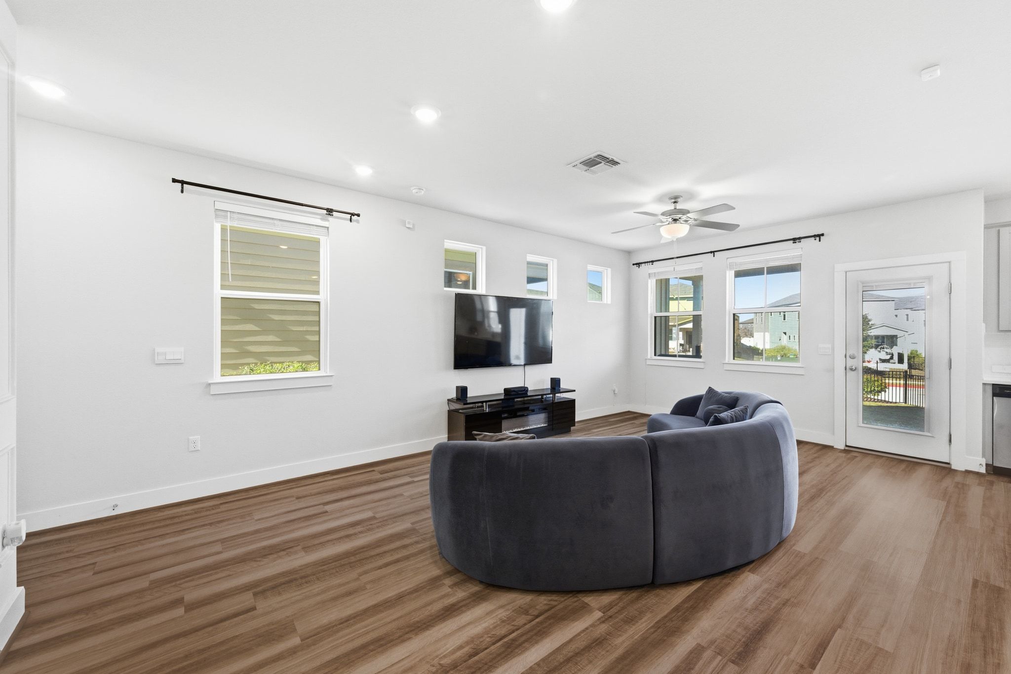 7416 Travertine Spring Drive, Unit 149 Austin, TX 78744 - Photo 8 of 36 a living room with furniture and a flat screen tv