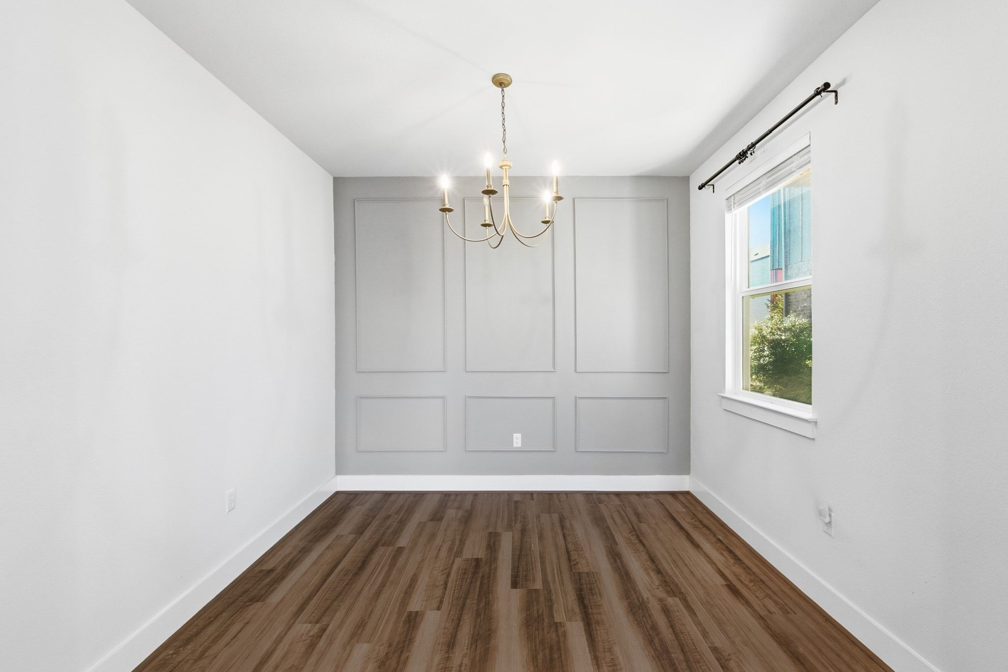 7416 Travertine Spring Drive, Unit 149 Austin, TX 78744 - Photo 10 of 36 an empty room with wooden floor exposed radiator and windows