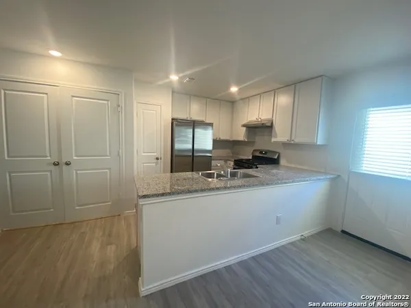 a kitchen with stainless steel appliances granite countertop a sink and cabinets