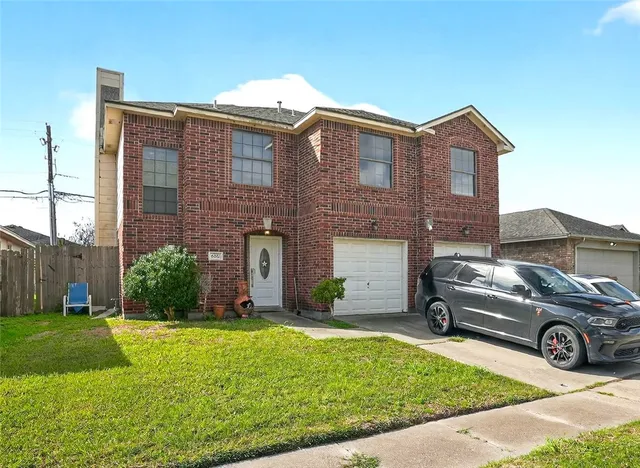 a view of a car parked in front of a brick house