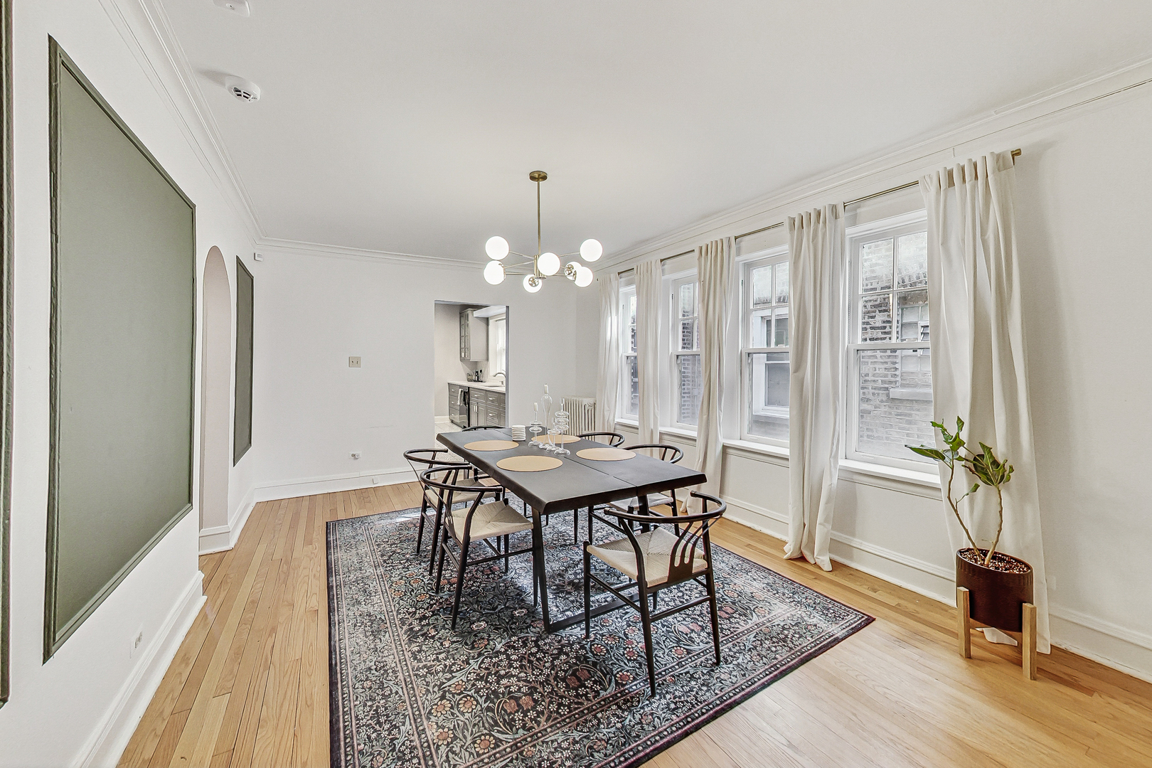 138 Custer Avenue, Unit 2 Evanston, IL 60202 - Photo 11 of 22 a dining room with wooden floor a chandelier a wooden table and chairs