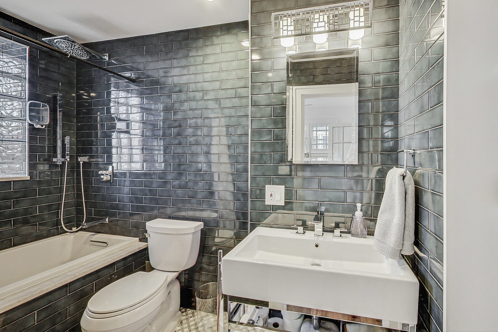 138 Custer Avenue, Unit 2 Evanston, IL 60202 - Photo 15 of 22 a bathroom with a sink toilet and shower