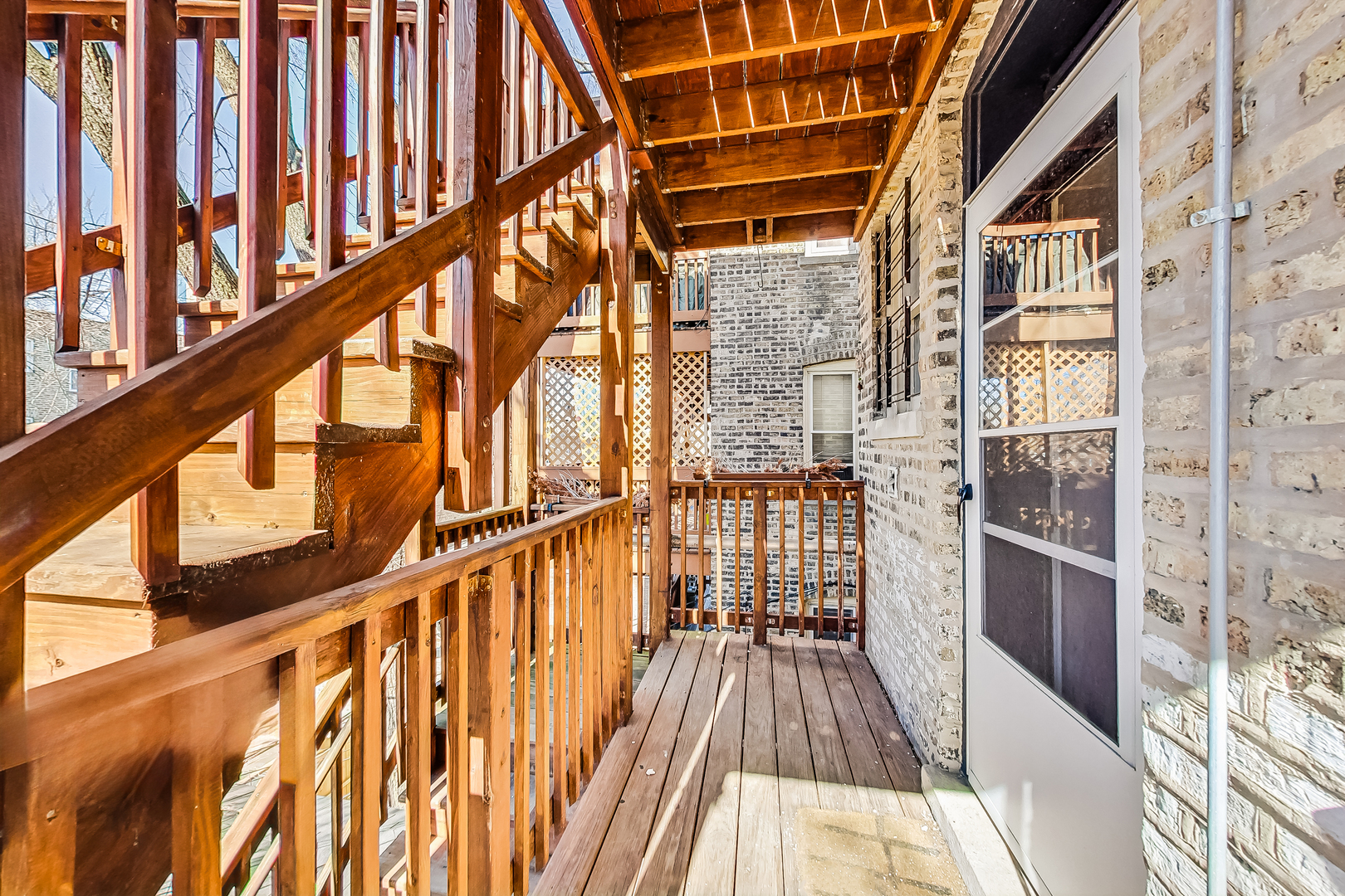 138 Custer Avenue, Unit 2 Evanston, IL 60202 - Photo 22 of 22 a view of balcony with wooden floor and stairs