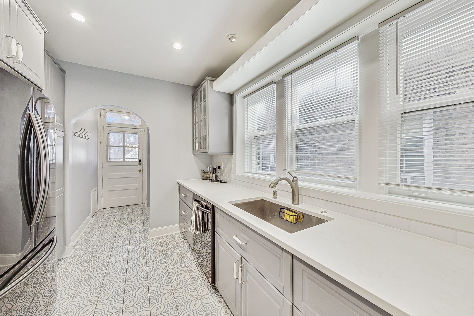 138 Custer Avenue, Unit 2 Evanston, IL 60202 - Photo 7 of 22 a kitchen with stainless steel appliances granite countertop a sink and a refrigerator