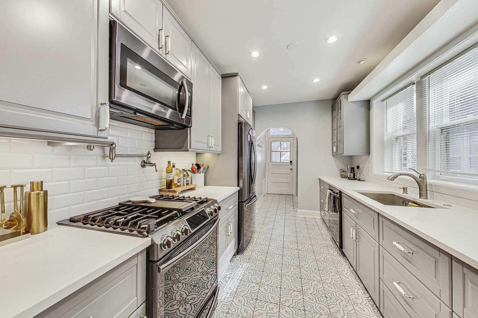 138 Custer Avenue, Unit 2 Evanston, IL 60202 - Photo 8 of 22 a kitchen with stainless steel appliances a sink stove and cabinets