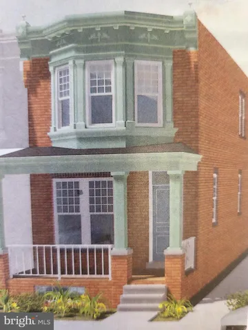 a view of a brick building next to a yard