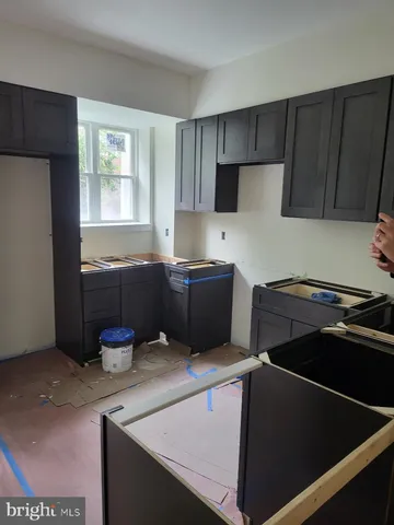 a kitchen with kitchen island a stove and a refrigerator