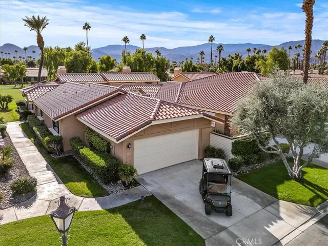 a view of a patio with table and chairs and potted plants