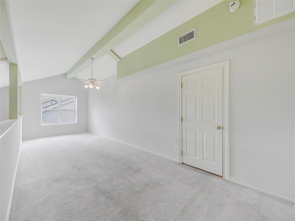 1716 East Parker Road Plano, TX 75074 - Photo 23 of 25 Spacious Loft featuring vaulted ceilings with exposed beams, light gray carpeting, and a multi-pane window
