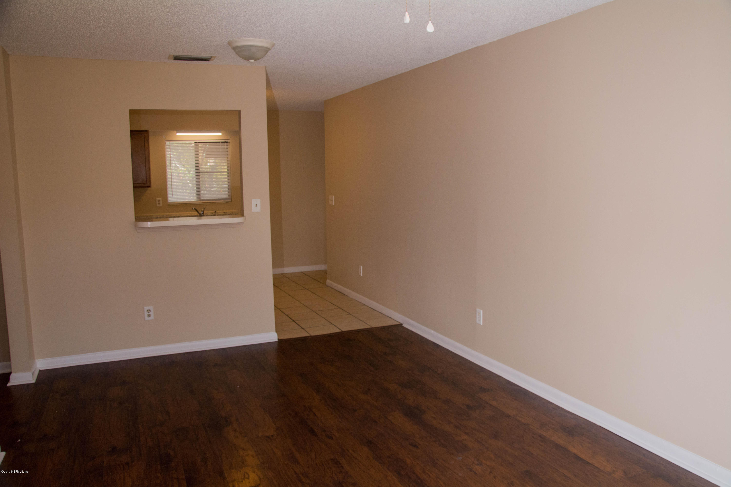 2630 Jammes Road, Unit 403 Jacksonville, FL 32210 - Photo 4 of 10 an empty room with wooden floor and windows