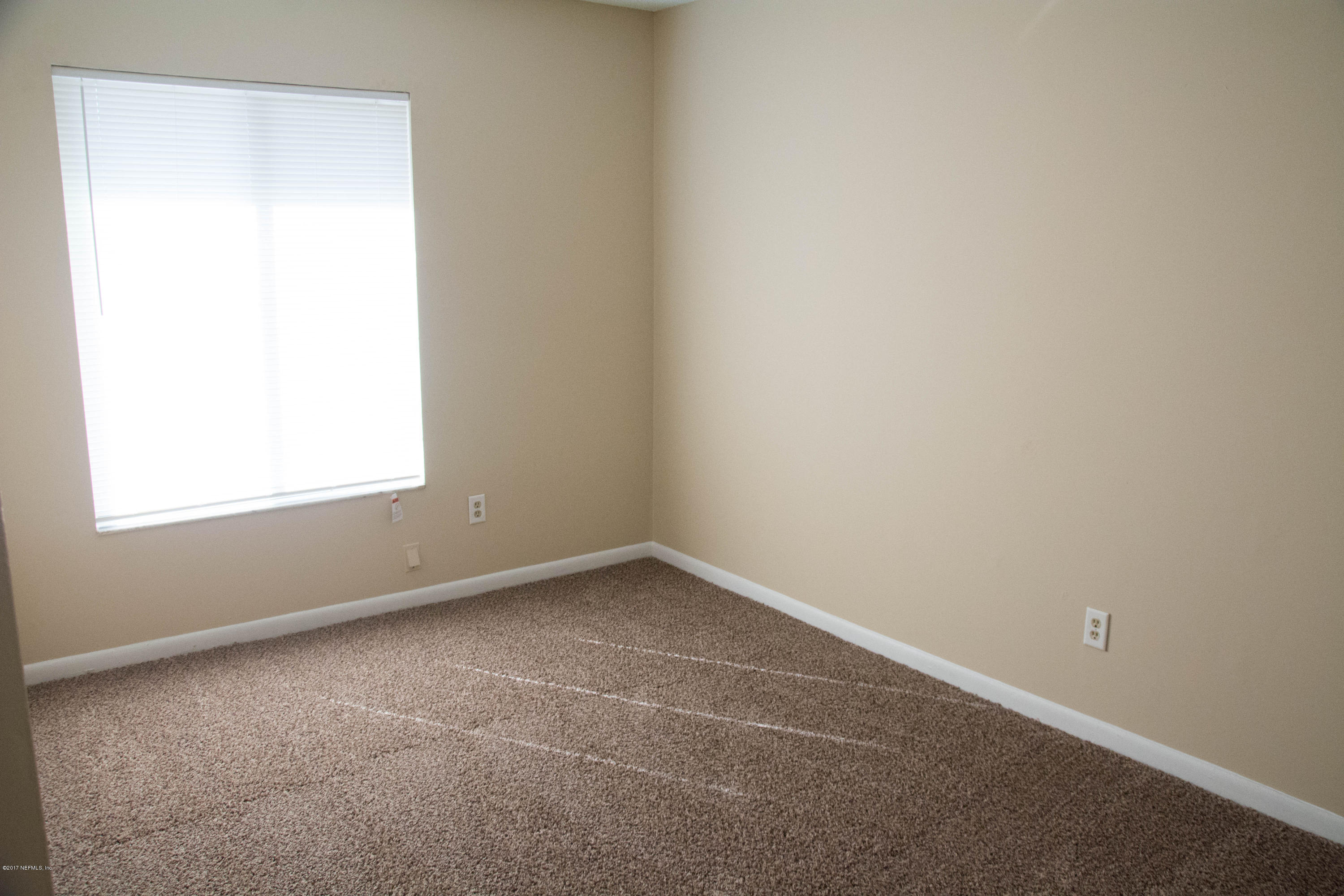 2630 Jammes Road, Unit 403 Jacksonville, FL 32210 - Photo 5 of 10 an empty room with a window