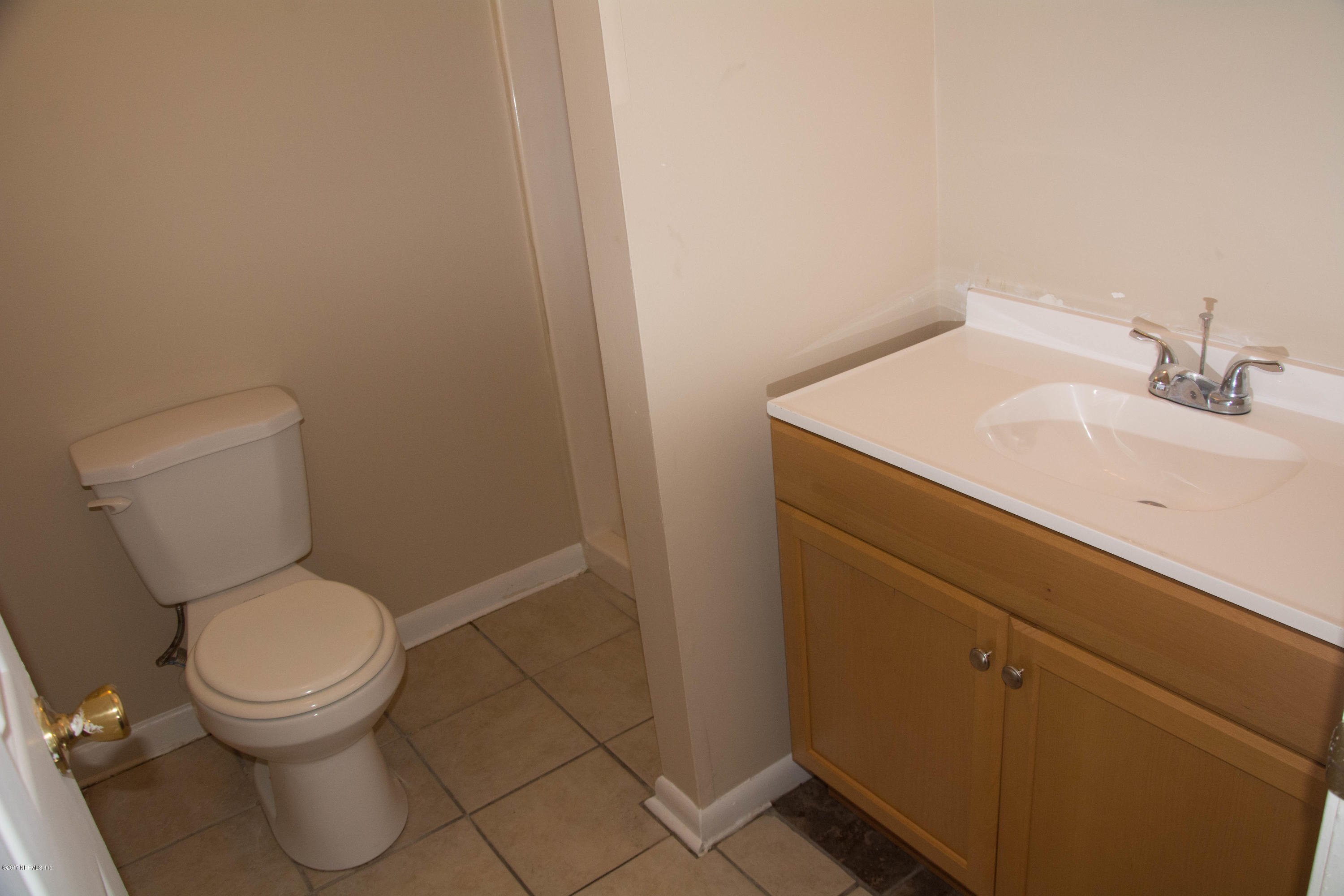 2630 Jammes Road, Unit 403 Jacksonville, FL 32210 - Photo 9 of 10 a white toilet sitting next to a bathroom sink