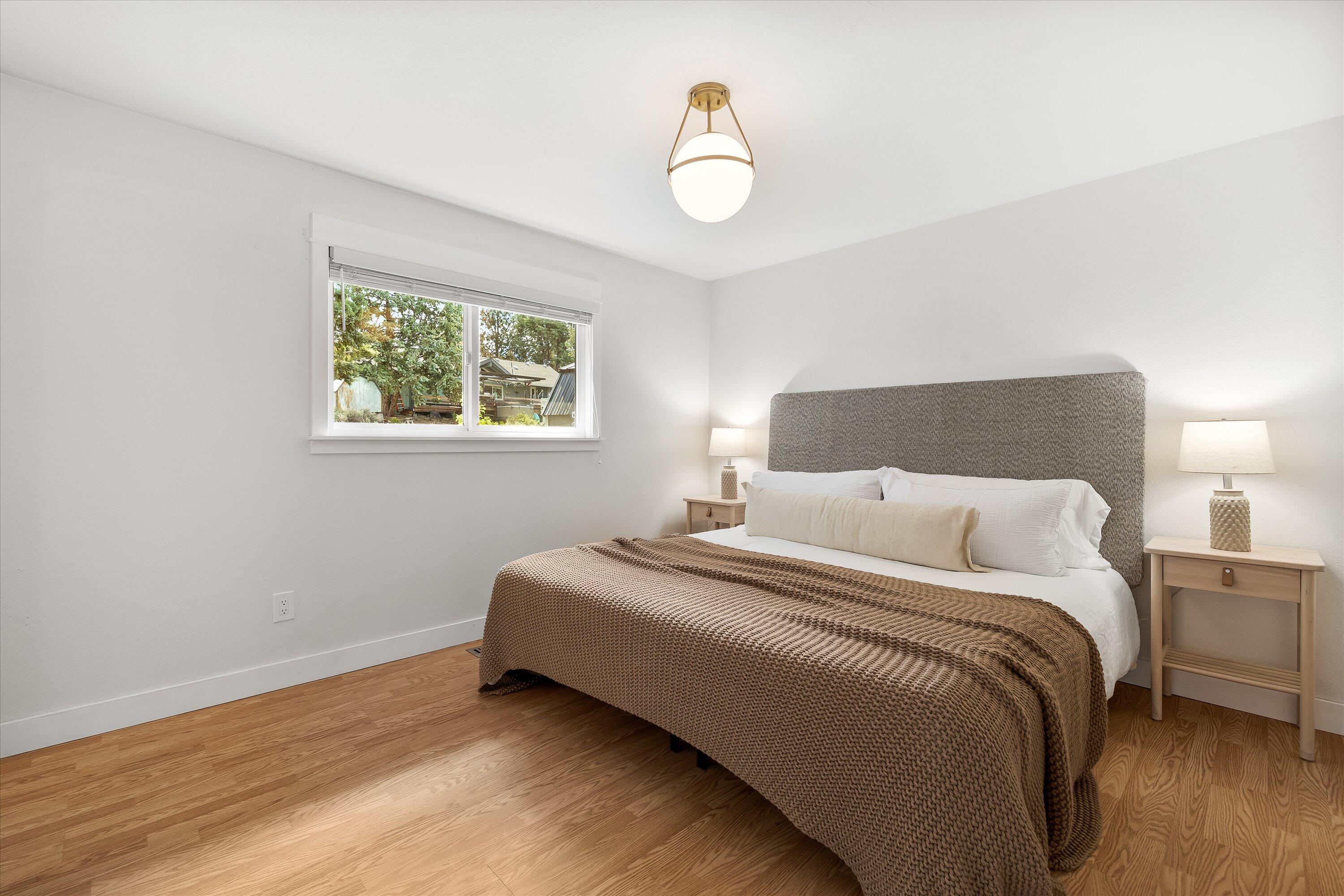 63634 Hunters Circle Bend, OR 97701 - Photo 9 of 28 a bedroom with a bed and a window