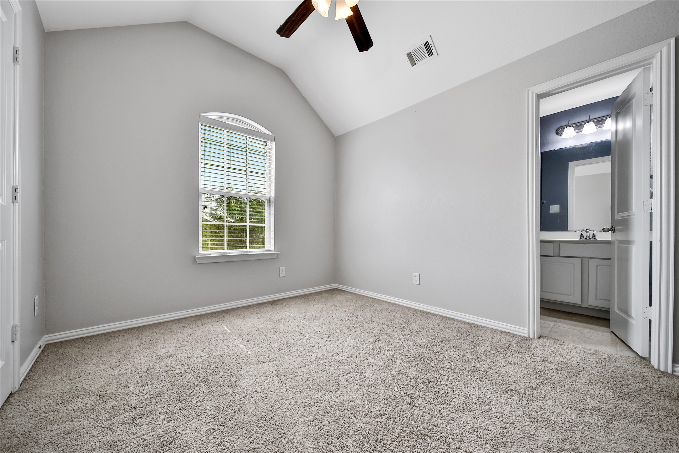 3910 Lupin Bush Lane Manvel, TX 77578 - Photo 21 of 39 an empty room with chandelier fan and windows