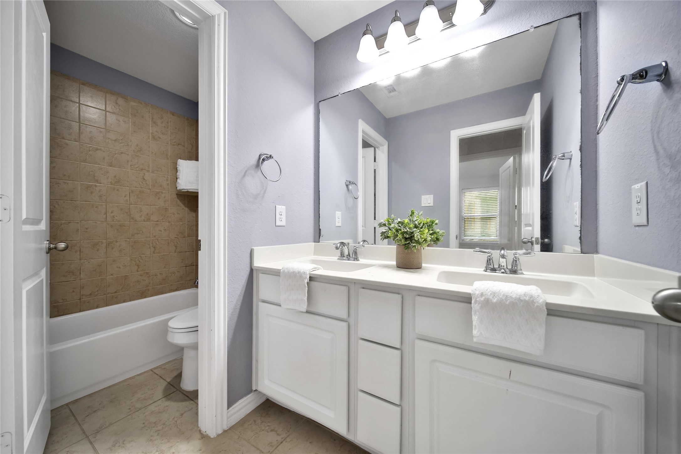 3910 Lupin Bush Lane Manvel, TX 77578 - Photo 22 of 39 a bathroom with a sink a toilet and a large mirror