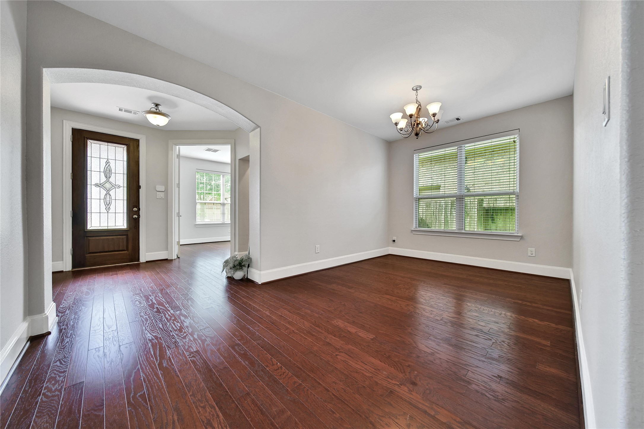 3910 Lupin Bush Lane Manvel, TX 77578 - Photo 5 of 39 an empty room with wooden floor and windows