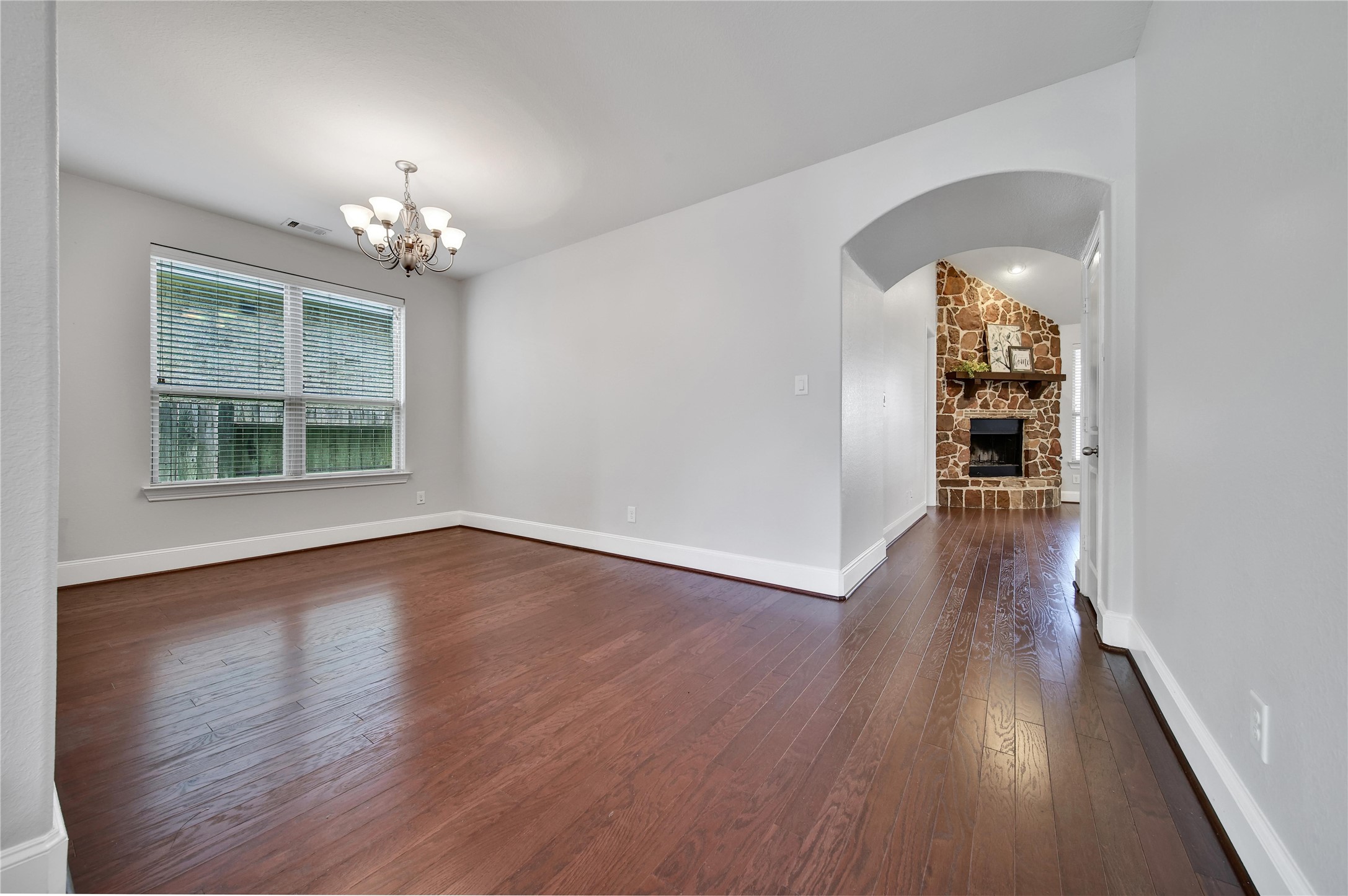 3910 Lupin Bush Lane Manvel, TX 77578 - Photo 6 of 39 wooden floor in an empty room with a window