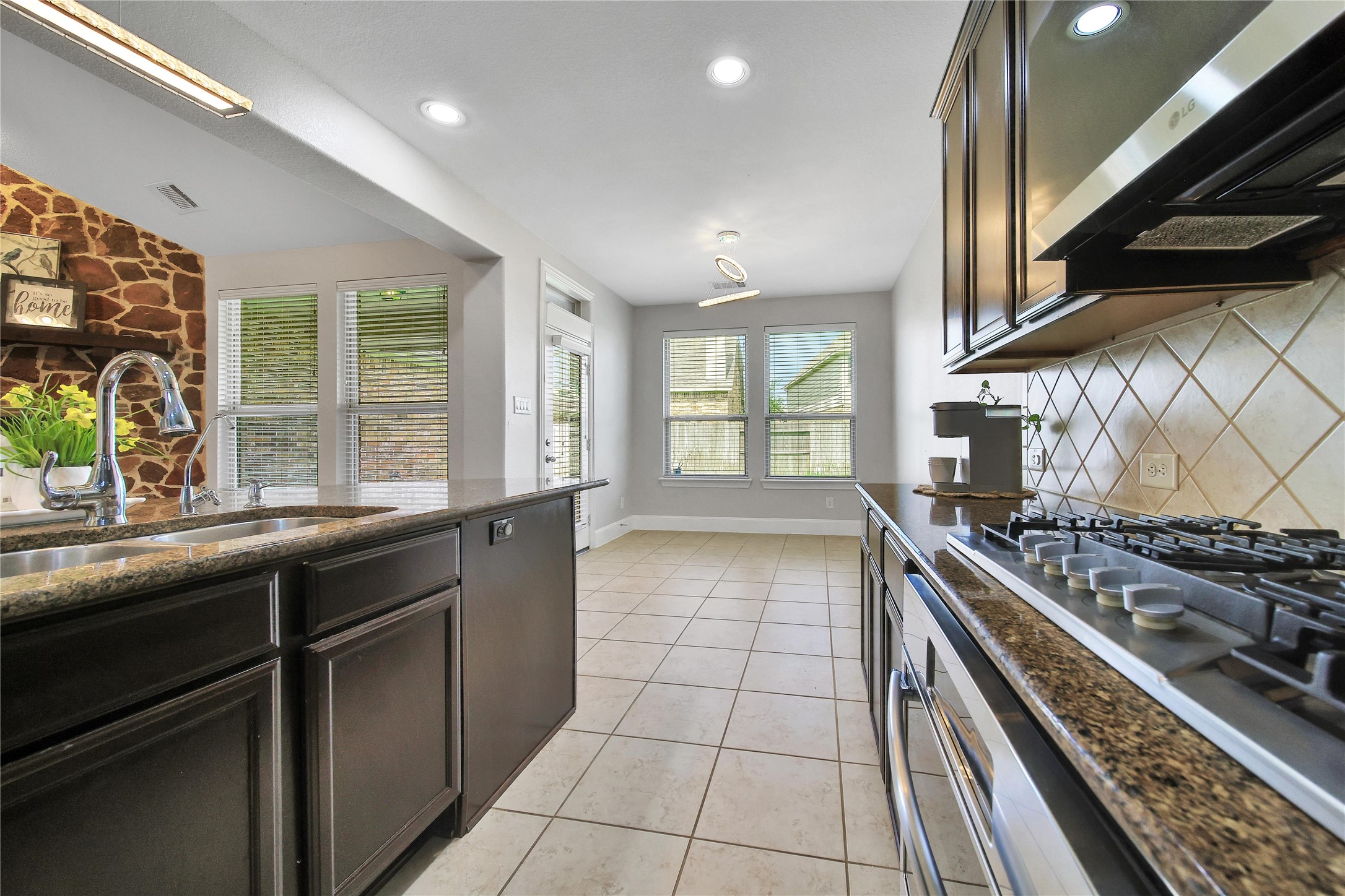 3910 Lupin Bush Lane Manvel, TX 77578 - Photo 9 of 39 a kitchen with stainless steel appliances granite countertop a stove and a sink