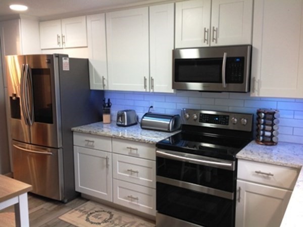 70 Gary Road Springfield, MA 01119 - Photo 5 of 24 a kitchen with stainless steel appliances white cabinets and a stove