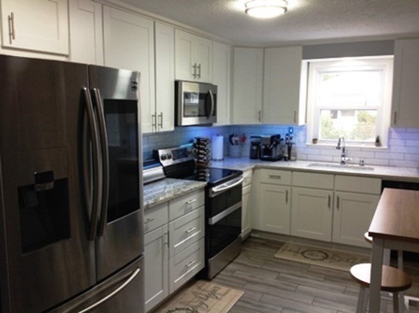 70 Gary Road Springfield, MA 01119 - Photo 6 of 24 a kitchen with a sink stainless steel appliances and cabinets