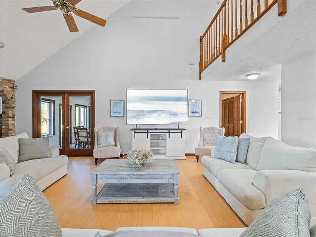 a spacious bedroom with a bed and a flat screen tv