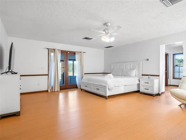 a spacious bathroom with a double vanity sink a mirror and a toilet
