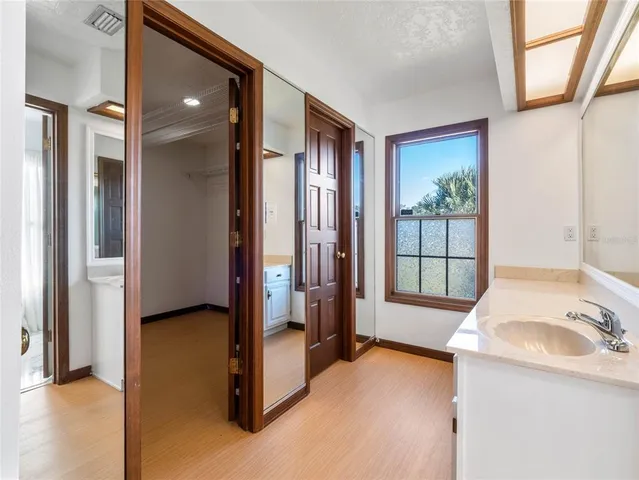 a bedroom with a bed and a night stand