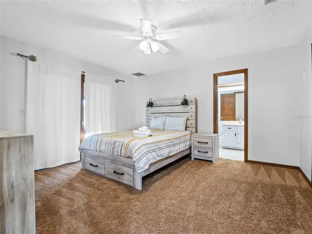 a very nice looking room with lots of white furniture