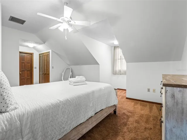 an aerial view of a houses with a lake view